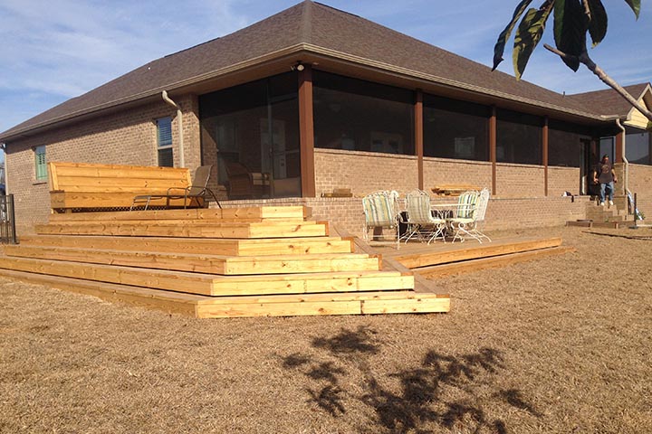 A wooden deck with stairs expands the house into the patio while enhancing the aesthetics and value of the housr