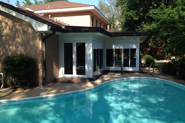 A sunroom in Fairhope, Alabama, designed to match the setting of an adjacent pool becomes a natural extension of the house