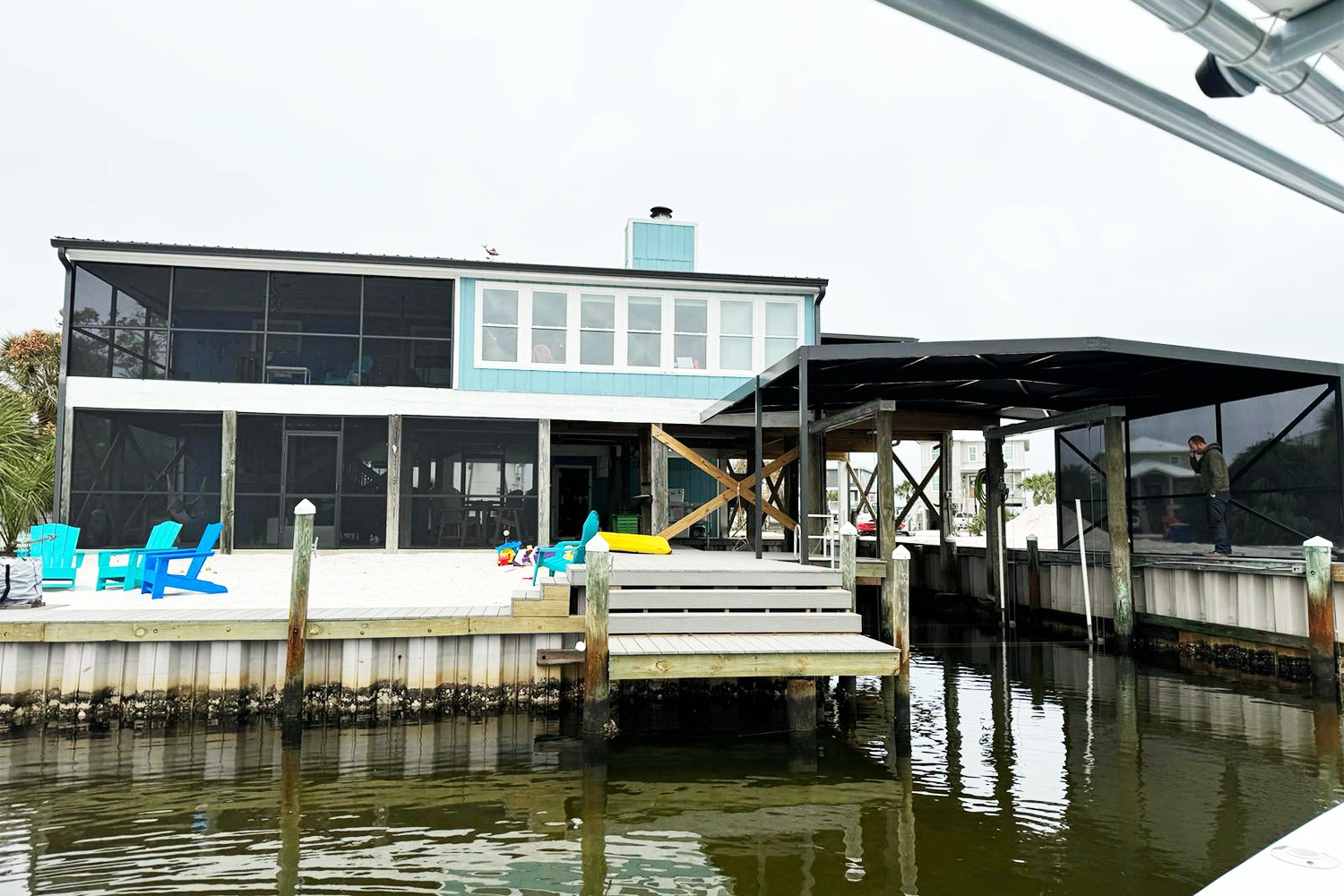 Custom aluminum carport providing covered boat storage over the water in South Alabama