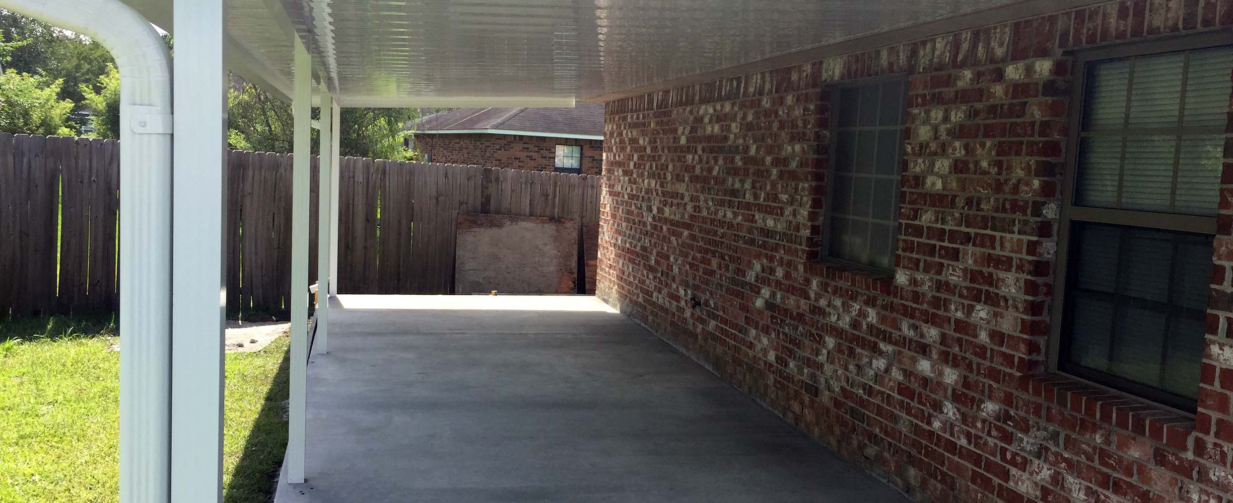 Custom patio cover adding shade and shelter to a South Alabama outdoor living space