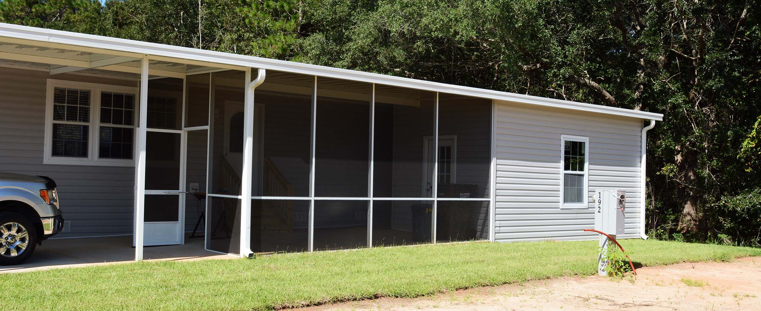 Custom screen room providing protected outdoor living at a South Alabama home