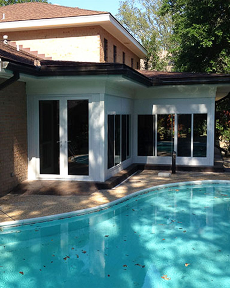 Custom sunroom overlooking a backyard pool at a South Alabama home