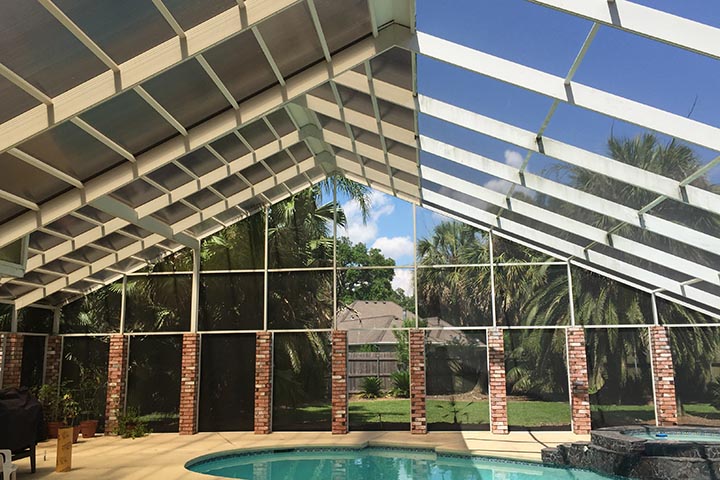 Partially roofed Lexan pool enclosure with screened walls
