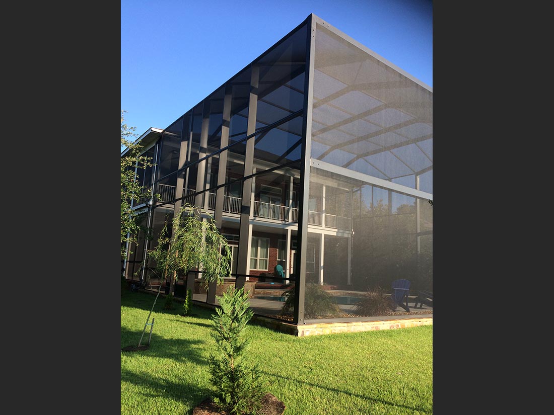 Exterior side view of a tall MegaView pool enclosure in South Alabama