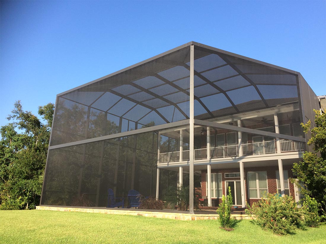 Custom-engineered MegaView pool cage enclosing a two-story South Alabama home