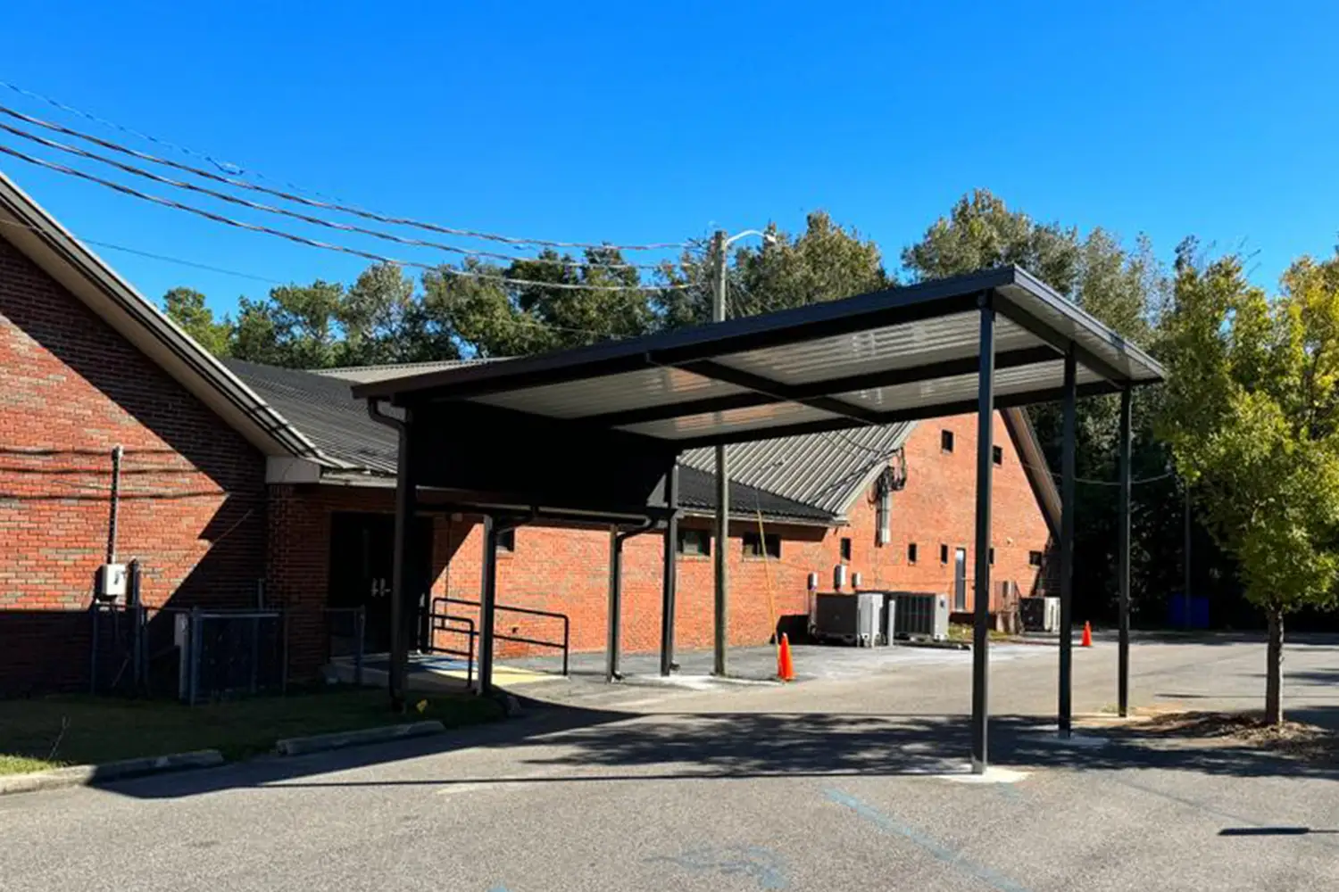 Custom aluminum patio cover extending a South Alabama home into a shaded outdoor living area