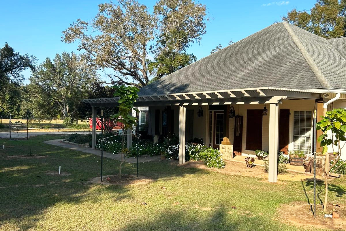 Custom aluminum pergola defining a South Alabama outdoor living area