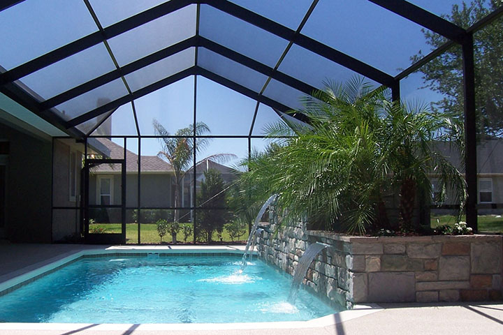 White aluminum swimming pool enclosure with clear backyard views in Baldwin County