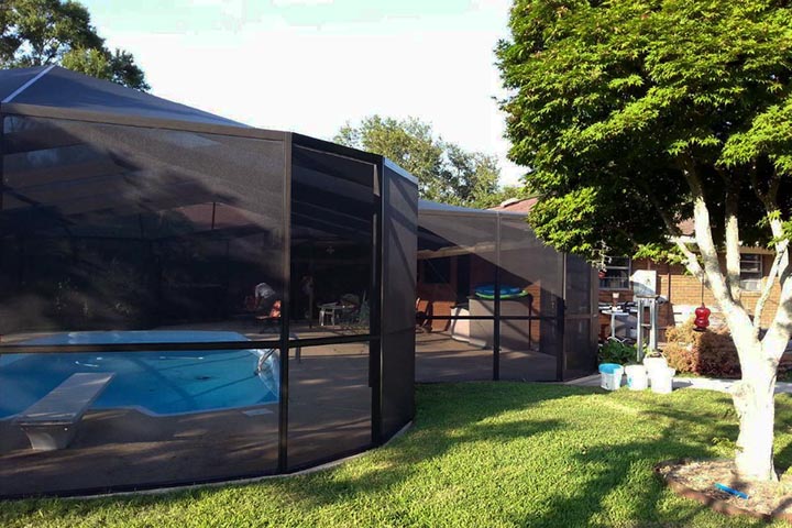 Residential screened pool enclosure creating protected outdoor living space