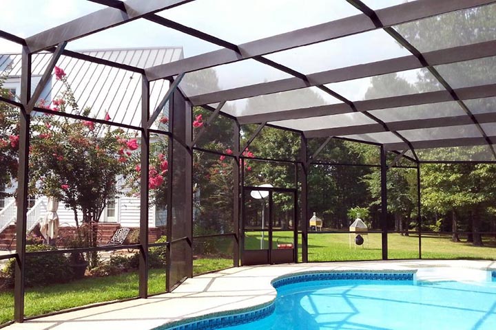 Custom pool screen enclosure attached to a Gulf Coast residence